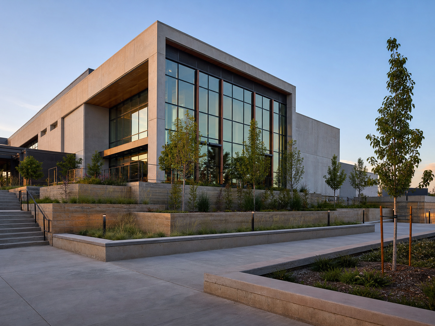 Completed contemporary commercial concrete building and hardscape plaza.
